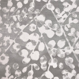 Close-up view of a fabric with a floral pattern in a gray and blue color palette.