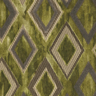 Close-up of a green velvet fabric with geometric patterns and metallic accents.