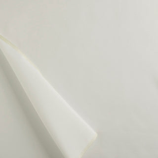 A beige piece of fabric with a rolled edge, representing a sample of drapery lining material.