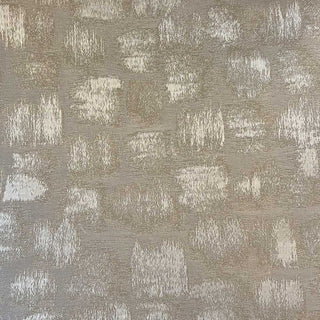 Close-up of a beige and gray abstract patterned fabric with metallic accents.