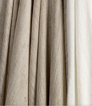 Kravet Aloft drapery collection Close-up of pleated fabric in beige and white.