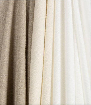 Kravet Aloft drapery collection Close-up of beige and white fabric swatches.