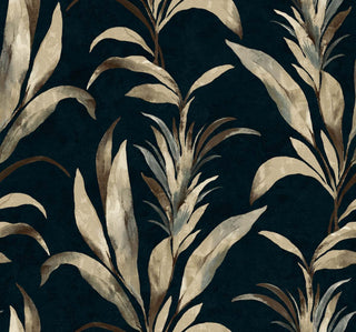 Crown Bali Tropical Padma wallpaper featuring a dramatic botanical design. Tall, stylized tropical leafy foliage in cream and light grey tones stands gracefully against a textured navy blue background, creating a moody, sophisticated accent wall.