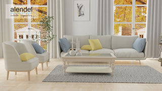 Living room with Alendel gray upholstered sofa, armchair, and coffee table with Alendel white drapery framing window.