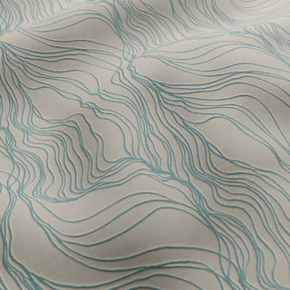 Textured fabric with wavy line pattern on a beige background