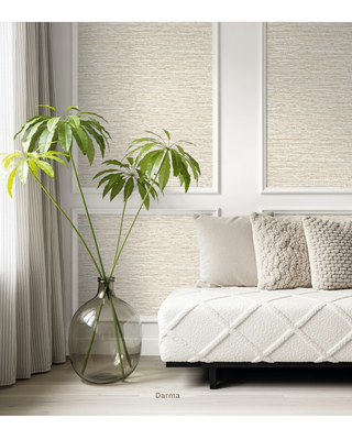 Beige textured wall panels with a woven damask pattern, styled in a modern living room setting next to a white quilted daybed and a large glass vase with green leaves.