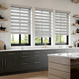 Modern kitchen with gray cabinets, a white countertop, and three windows Alta with banded shades