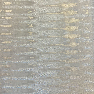 Textured fabric pattern with gold and silver accents on a gray background