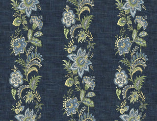 A close-up view of the Callas wallpaper swatch from the Crown Provence collection. The design features rich, vertical trails of intricate botanical florals, vines, and ornate blossoms in blue, soft yellow, white and sage green tones. These vibrant, folk-inspired floral stripes repeat gracefully across a dark denim blue background. The backdrop is enhanced with a tactile, linen-look faux weave texture that gives the pattern a warm, high-end fabric appearance, blending rustic charm with elegant detail.