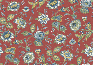 A close-up view of the Castellane wallpaper swatch from the Crown Provence collection. The pattern features a sprawling, traditional floral trail design with detailed botanical blossoms, twisting stems, and leafy sprigs. The flowers and foliage are illustrated in soft shades of French blue, cream, and olive green, contrasting beautifully against a rich terracotta-red background. A subtle, linen-textured faux weave runs across the surface, giving the elegant, country-cottage print 