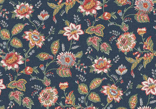 A close-up view of the Castellane wallpaper swatch from the Crown Provence collection. The pattern features a sprawling, traditional floral trail design with detailed botanical blossoms, twisting stems, and leafy sprigs. The flowers and foliage are illustrated in soft shades of red, white, and greeen, contrasting beautifully against a denim blue background. A subtle, linen-textured faux weave runs across the surface, giving the elegant, country-cottage print an inviting, fabric-like de