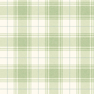A close-up view of the Gordes wallpaper swatch from the Crown Provence collection. The pattern features a charming country cottage plaid design with pale green and cream checks woven together. Accentuated by thin, delicate intersecting light blue lines, the classic tartan pattern is overlaid on a fine linen-textured faux weave. The subtle fabric-like backdrop lends warmth and depth to the crisp geometric lines, offering a sweet, traditional, and welcoming aesthetic