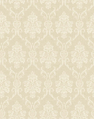 A close-up view of the Istres wallpaper swatch from the Crown Provence collection. The pattern features an ornate, classic damask motif showcasing elegant floral bouquets in stylized urns, enclosed by delicate scrolling acanthus leaves. The intricate design is rendered in a off-white tone that sits subtly against a warm, light beige background. The backdrop is enhanced with a fine, linen-textured faux weave, giving the traditional pattern a tactile, fabric-like depth and a serene, sophisticated feel.