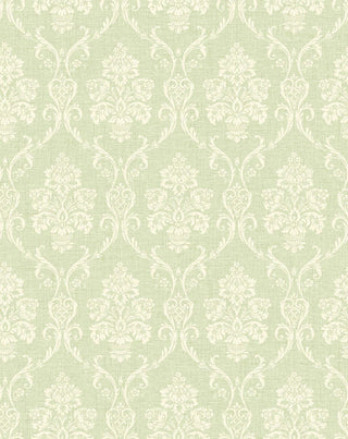 A close-up view of the Istres wallpaper swatch from the Crown Provence collection. The pattern features an ornate, classic damask motif showcasing elegant floral bouquets in stylized urns, enclosed by delicate scrolling acanthus leaves. The intricate design is rendered in a off-white tone that sits subtly against a light greern background. The backdrop is enhanced with a fine, linen-textured faux weave, giving the traditional pattern a tactile, fabric-like depth and a serene, sophisticated feel.