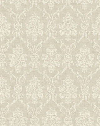A close-up view of the Istres wallpaper swatch from the Crown Provence collection. The pattern features an ornate, classic damask motif showcasing elegant floral bouquets in stylized urns, enclosed by delicate scrolling acanthus leaves. The intricate design is rendered in a soft cream tone that sits subtly against a warm, light beige background. The backdrop is enhanced with a fine, linen-textured faux weave, giving the traditional pattern a tactile, fabric-like depth and a serene, sophisticated feel.