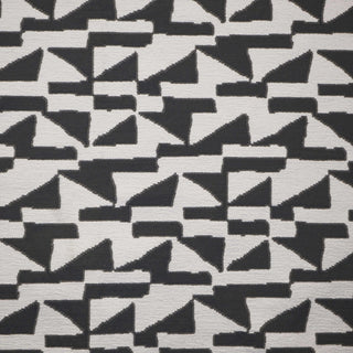 JF Fabrics Marisol collection, a close-up of an edgy abstract pattern of charcoal grey and white geometric shapes on a textured fabric background