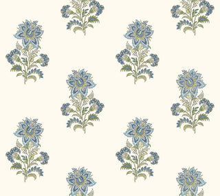 A close-up view of the Sellans wallpaper swatch from the Crown Provence collection. The pattern features an elegant, repeating Indian block-print inspired floral motif arranged in a staggered, half-drop layout. Each delicate botanical sprig showcases a prominent stylized blossom surrounded by smaller buds and detailed foliage in soft shades of French blue, dusty denim, and sage green. The intricate design is set against a clean, warm cream background, offering a serene, traditional aesthetic.