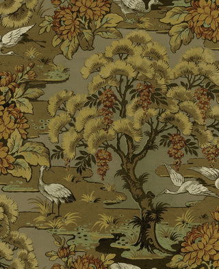 Close-up swatch of Crown's Chinoiserie collection wallpaper in the Hanae Trees pattern. The design features a textured, taupe faux-grasscloth or linen background. A stylized, artistic tree trunk climbs vertically, showcasing painterly branches in soft green. The tree is densely packed with large, rounded, overlapping flower heads or foliage clusters in contrasting shades of yellow, green, and taupe, creating a modern and sophisticated botanical look.