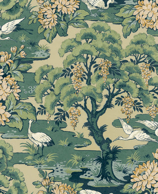 Close-up swatch of Crown's Chinoiserie collection wallpaper in the Hanae Trees pattern. The design features a textured, beige faux-grasscloth or linen background. A stylized, artistic tree trunk climbs vertically, showcasing painterly branches in soft green. The tree is densely packed with large, rounded, overlapping flower heads or foliage clusters in contrasting shades of greens, and beige, creating a modern and sophisticated botanical look.