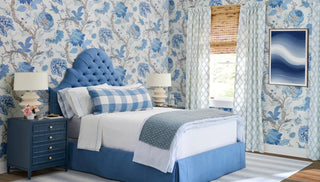 Kravet fabric Blue upholstered bed in a bedroom with Kravet wallpaper floral wallpaper and matching curtains.