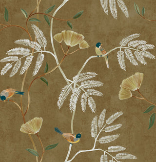 Close-up swatch of Crown's Chinoiserie collection wallpaper in the Kohana Branch pattern. Set against a textured, gold background with a soft matte finish, the design features delicate botanical trails in white and brown. The branches are decorated with large, stylized fan-shaped blossoms in yellow and rows of small, fern-like pinnate leaves in white. Several small, detailed songbirds with teal heads and golden-brown feathers are perched throughout the branches.