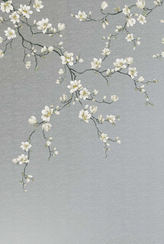 A wallpaper swatch from Crown’s Chinoiserie collection featuring the Miyabi Bloom Mural, with delicate flowering branches extending diagonally across a soft gray background. White blossoms with subtle pink centers and light green leaves create an airy, elegant composition. The design evokes a serene, hand‑painted botanical scene with a refined, tranquil aesthetic