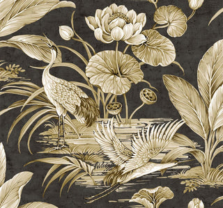 Close-up swatch of Crown's Chinoiserie collection wallpaper in the Tsuru Bird pattern. The detailed scenic design features a grey background with a subtle, distressed plaster patina. Beautifully rendered in soft white and gold tones are elegant cranes or storks amidst a serene wetland; one stands tall with its beak open, while another glides in mid-flight over the water. Large blooming lotus flowers, rounded lily pads, seed pods, and lush tropical fronds complete the opulent landscape